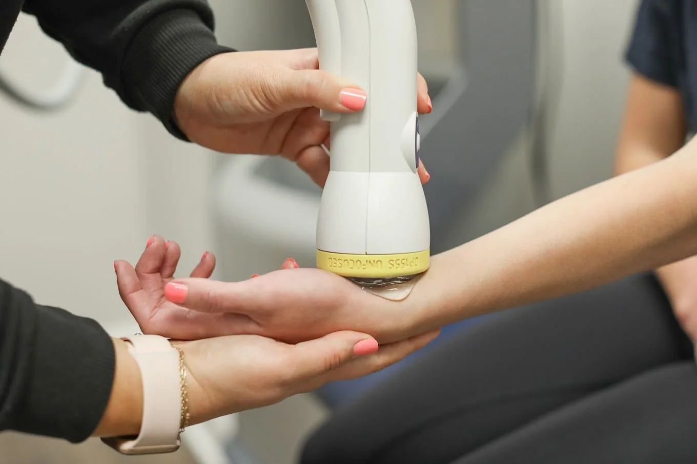 Patient receiving SoftWave therapy treatment on their wrist